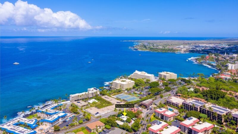 This aerial view shows the Kona Beach Hostel in the foreground looking south.
