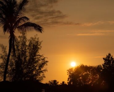 Say 'aloha' to another perfect Hawaiian day as the sun sets over the Pacific ocean and lights up the sky with all kinds of beautiful orange colors.