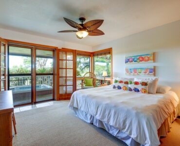 Downstairs bedroom with french doors opening to jetted hot tub